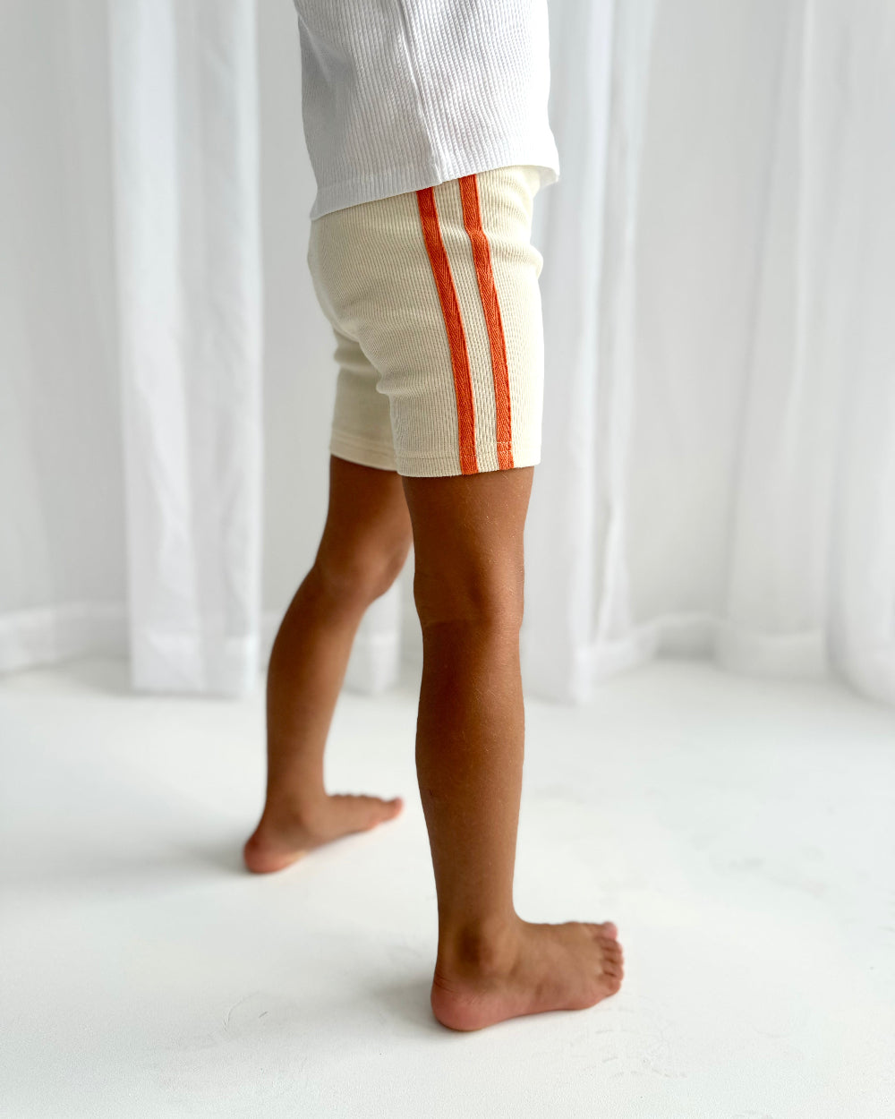 ribbed cream bike shorts with orange stripes