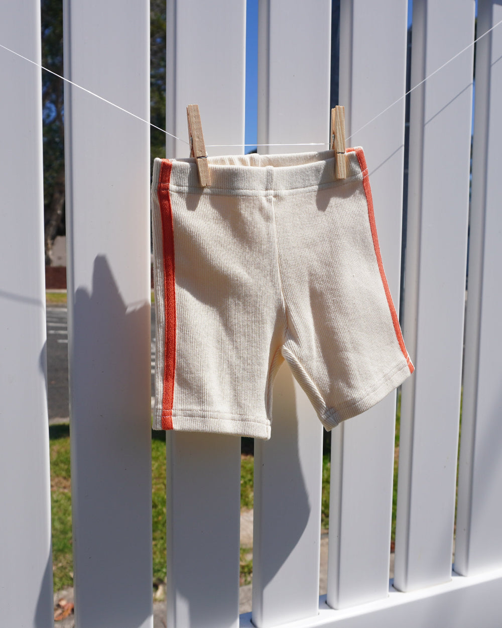 ribbed cream bike shorts with orange stripes