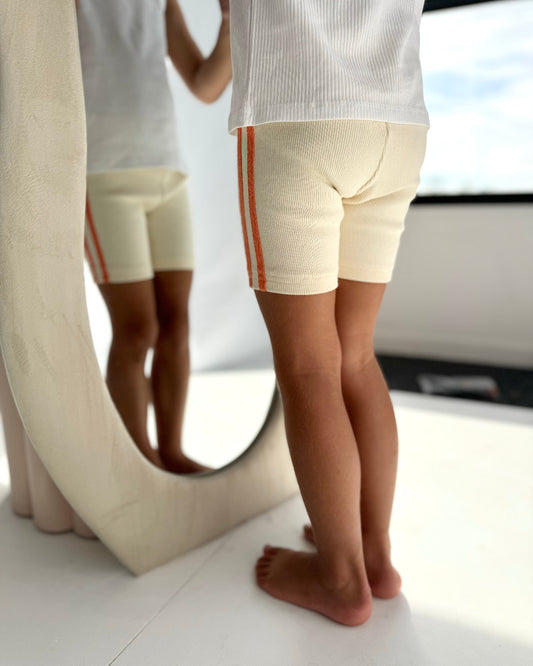 Girls ribbed bike shorts, cream with orange stripes